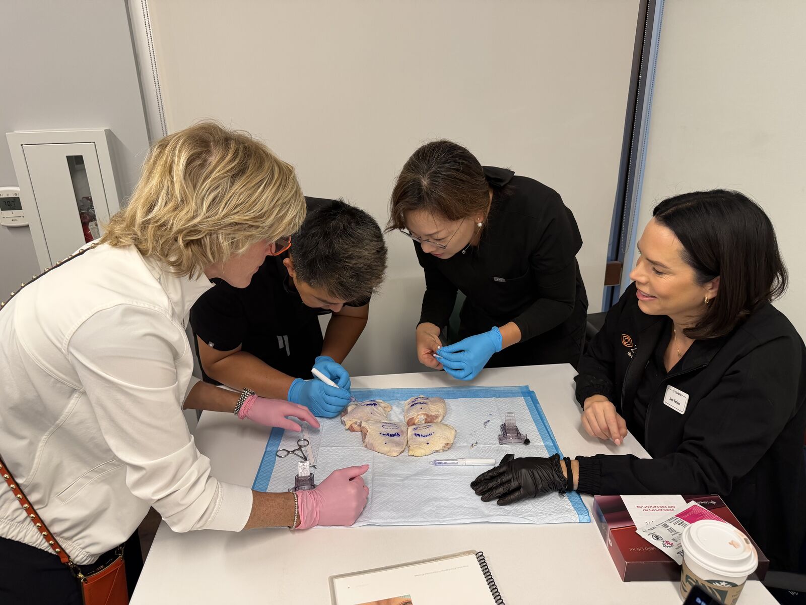 A physician and the Osheru clinical team reviewing materials together at a training table