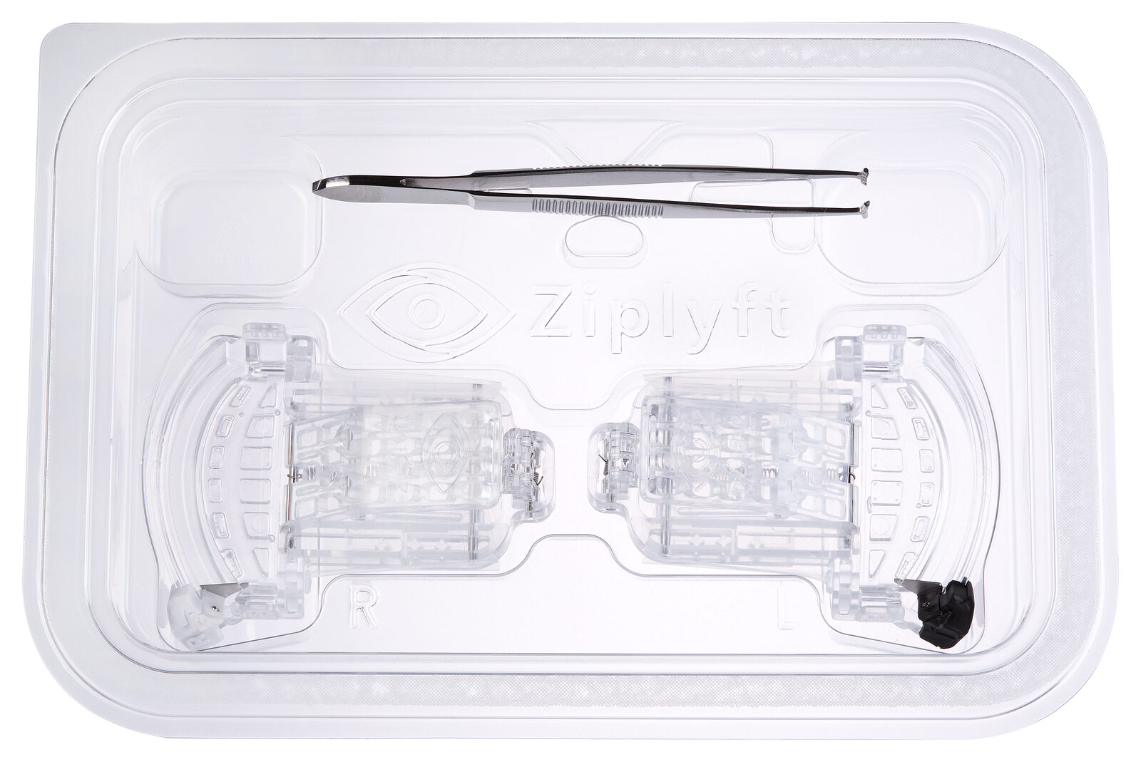 An open Ziplyft kit tray with the right- and left-eye devices and fixation forceps